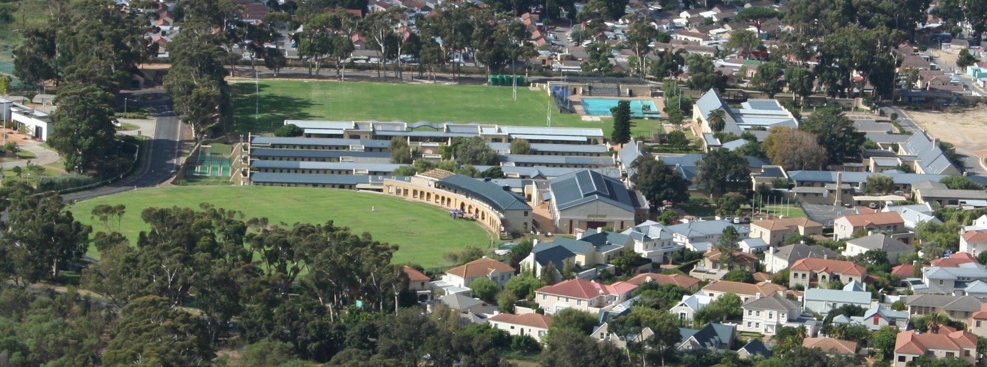 Aerial view over a leafy school campus and its sports fields in Cape Town
